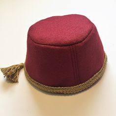 "Cranberry Red Fez Hat, Tarboush Hat, Aladdin Hat for Toddlers, Kids, & Teens, & Adults -Genie Hat -Crimson & Gold Hat -Birthday Hat -Party Hat Beautiful deep cranberry red (available also in purple.  Check out other listing) felt fabric is soft and comfortable to wear in a medium weight.  Hat is completely lined and has a beautiful gold trimming and a 2-inch gold tassel.  Attention to detail is a must with all my costumes, so with that in mind, all seams are reversed inside lining giving it a \ Fez Hat, Old Halloween Costumes, Hat Birthday, Gold Hat, Milestone Pictures, Hat Party, Gold Hats, Birthday Hat, Costume Hats