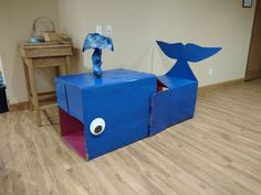 two cardboard animals are sitting on top of each other in the middle of a room