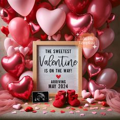 valentine's day greeting card with red heart balloons and baby booties in front of it