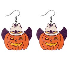 a pair of halloween earrings with pumpkins and witches hats on them, hanging from hooks