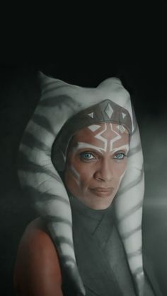 a woman with blue eyes wearing a star wars costume and a white mask on her head