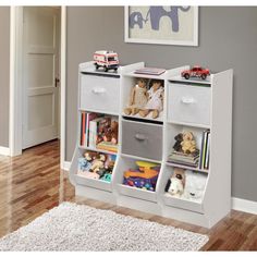 a white bookcase with four bins filled with toys