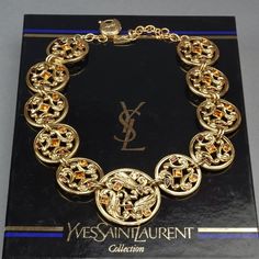 Features: - 100% Authentic YVES SAINT LAURENT. - Openwork medallion links with rhinestones embellishments. - Adjustable lobster spring closure. - Gold tone hardware. - Signed YSL Made in France. - Comes with YSL box - Excellent vintage condition. Measurements: Height: 1.81 inches (4.6 cm) Width: 17.71 inches (45 cm) to 19.68 inches (50 cm) **This necklace will be shipped via Priority Shipping with tracking number. Please convo me for any queries and additional photos. Thank you for visiting. Oth Ysl Box, Vintage Yves Saint Laurent, Chunky Chain Necklaces, Jeweled Earrings, Disc Necklace, Earrings Photo, Vintage Chanel, Made In France, Tracking Number