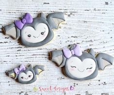 two decorated sugar cookies with bats on them