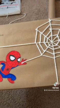 a spiderman gift wrapped in brown paper