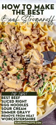 a bowl filled with pasta and meat on top of a wooden table next to a fork