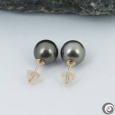 Lovely classic stud earrings, made of 14K solid yellow gold with an organic natural color, Tahitian South Sea cultured pearls from French Polynesia. Each of the genuine saltwater pearl exhibits a high luster, thicker nacre & smooth surface with just a minor natural spots. Style: Classic Hook. Metal Purity: 14K solid yellow gold. Fastening: 14K Solid yellow Gold. Closure: Butterfly ear-backs with silicone jackets. Pearl Type: Genuine Tahitian Seawater Cultured Pearl. Pearl Origin: French Poly Classic Tahitian Pearl Earrings As Gift, Classic Tahitian Pearl Earrings For Gift, Classic Gold Tahitian Pearl Earrings, Classic Tahitian Pearl Earrings, Golden South Sea Pearls, Saltwater Pearls, French Polynesia, South Seas, South Sea Pearls