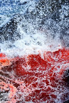 red and white waves crashing into the ocean