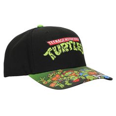 Celebrate your favorite cartoon characters in style with this Teenage Mutant Ninja Turtles snapback hat. The cap features an image of the four turtles on the curved bill while the cartoon's logo appears in white and green letters on the crown of the hat. The cap is made with high-quality mock acrylic materials and comes with an adjustable snapback strap to help you find the perfect fit. Fans of the classic TMNT cartoon series will love this comfy cap. Themed Adjustable Baseball Cap, Themed Adjustable Snapback Baseball Cap, Retro Cartoon Characters, Ninja Turtle Hat, Turtle Hat, New Era 9twenty, Product Tags, Hat Stand, Retro Cartoon