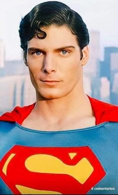 a close up of a person wearing a superman costume