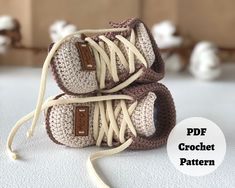 two crocheted baby shoes sitting on top of each other