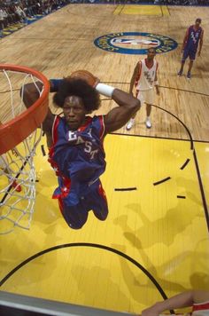 a basketball player dunking the ball into the hoop