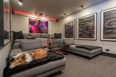 a living room with couches and pictures on the wall