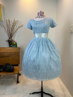 1950s dress / 50s dress / 1950s fit and flare / 1950s fit and flare  dress / 1950s fashion  This 1950s dress is stunning and has a gorgeous lace fabric on top of a shiny fancier which creates this matte shine. She has the classic fit and flare cut with the nipped waist, and a full skirt. She has a metal zipper in the back. Measurements provided are flat and have been doubled.  Bust 32"  Waist 26"  Hips free"   Length 38.5" Shoulders 13" ❤️ Condition: Excellent vintage condition. Flaw: The back of the skirt has a light black smudge mark. It's hard to see in the common if the skirt, but please see heavily lit photo. Ribbon used in photos not included. This item has been cleaned and is ready to wear. $148 includes domestic shipping and insurance. International shipping is $30. Please let me k 1950s Style A-line Vintage Wedding Dress, 1950s Style Fit And Flare A-line Vintage Dress, Vintage Fitted A-line Tea Length Dress, Retro Fit And Flare Tea-length Dresses, 1950s Style Vintage Wedding Dress, 1950s Style Dress With Fitted Bodice And Short Sleeves, 1950s Style Knee-length Midi Dress For Party, Vintage Event Dresses With Fitted Bodice And Short Sleeves, Vintage Fashion Knee-length Dresses With Fitted Bodice