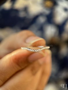 a person holding a diamond ring in their hand