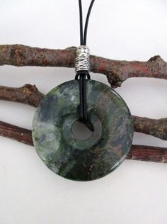 "Dendritic Serpentine Natural Semi-Precious Gemstone Donut Shape Energy Pendant Necklace. 50mm ED317 / ED317-1 / ED317-2 Pendant measures approx. 50 x 7mm = 2\" x ¼\". ¼\". PLEASE NOTE: Pendants might have small natural markings on them and is just part of its beauty and adds character to the piece. Suspended on a continuous 31\" brown leather cord strand without any clasp and accented with an silver tone Tibetan silver bead. The one you choose, is the one you will receive. From a smoke and pet Donut Jewelry, Donut Shape, Healing Properties, Semi Precious Gemstones, Leather Cord, Beautiful Necklaces, Semi Precious, Different Colors, Natural Gemstones