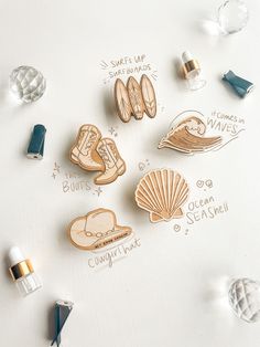 several wooden pins with different designs on them and some words written in gold ink next to each other