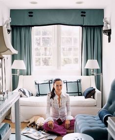 a woman sitting on the floor in her living room