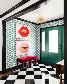 a black and white checkered floor with two paintings on the wall, one has red lips