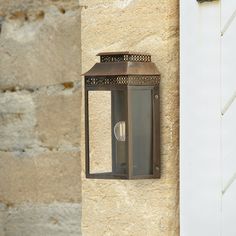 an old fashioned wall light on the side of a building