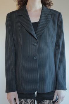 Best of 1990's classic minimalist cool Emporio Armani two button blazer. Great androgynous masculine style. Pin stripes on black background with white and grey stripes. Side front pockets. Fully lined. Slight shoulder pads give good shape to the shoulders. Label Emporio Armani, Made in Italy, Size 46. Dry clean only. 61% rayon, 30% pure wool, 5% nylon, 3% cotton, 1% polyester. Lining 100% rayon. Very good vintage condition with no fabric or sewing flaws. MeasurementsShoulders 44cm/ Chest 102cm/ Classic Striped Long Sleeve Blazer, Fitted Blazer With Vertical Stripes And Long Sleeves, Striped Blazer For Winter Workwear, Striped Long Sleeve Office Suits, Fitted Long Sleeve Blazer With Vertical Stripes, Striped Single-breasted Blazer For Office, Business Blazer With Vertical Stripes And Long Sleeves, Classic Single-button Striped Blazer, Classic Pinstripe Blazer For Office Wear