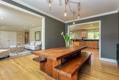 a living room filled with furniture and a wooden table