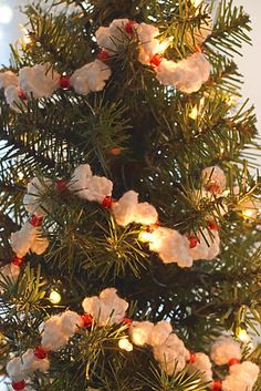 a close up of a christmas tree with lights and ornaments on it's branches