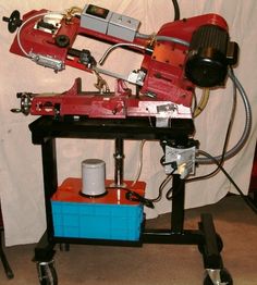 a machine that is sitting on top of a table next to a blue box and some tools