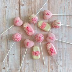 pink and white candy lollipops are arranged in a circle on a wooden table