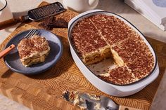 a cake in a pan with one slice cut out on a plate next to it