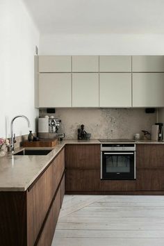 a kitchen with an oven, sink and counter tops in it's center island