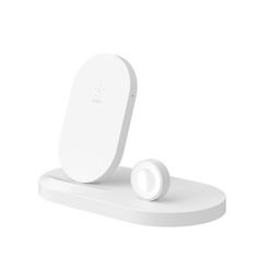 an electronic device is sitting on top of a white stand with its lid open and two buttons