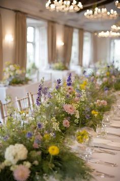 a long table is set with flowers and wine glasses for an elegant wedding reception at the grand america hotel