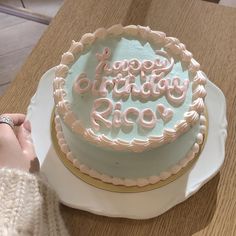 a birthday cake with frosting that says happy birthday rico on it and someone's hand next to it