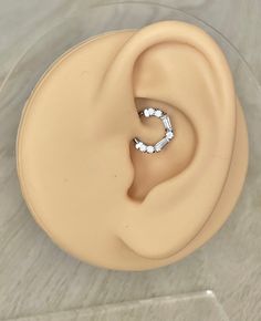 a pair of earring sitting on top of a plastic container