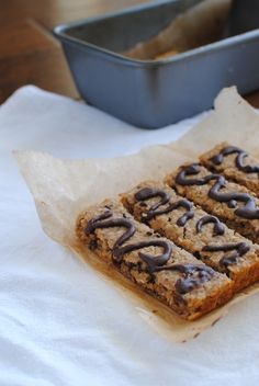 some food is sitting on a napkin next to a baking pan and a loaf of bread