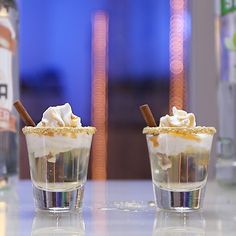 two shot glasses filled with ice cream and whipped cream