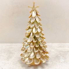 a small christmas tree made out of seashells