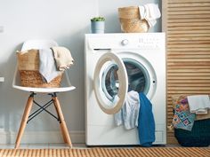 a washer sitting next to a dryer in a room