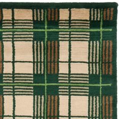 a green and brown rug with squares on it