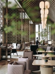 the interior of a restaurant with tables, chairs and lamps hanging from the ceiling above