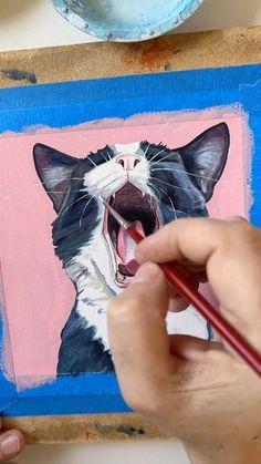 a person is painting a cat with colored pencils