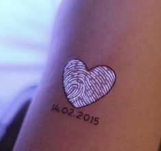 a fingerprint in the shape of a heart on someone's arm that reads i love 2012