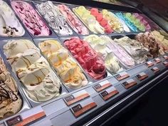 a display case filled with lots of different types of ice cream