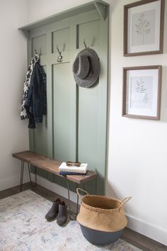 a coat rack and hat on a bench in a room