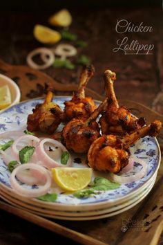 chicken legs with lemon slices and onions on a plate