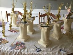 there are many vases that have gold decorations on top of the table together,