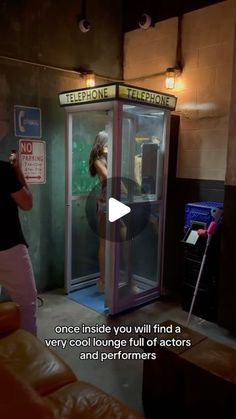 a woman standing in front of a phone booth