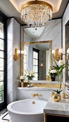 a white bath tub sitting under a large mirror next to a sink in a bathroom