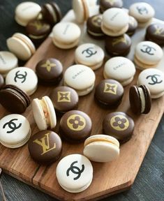 a wooden board topped with chocolate covered macaroons